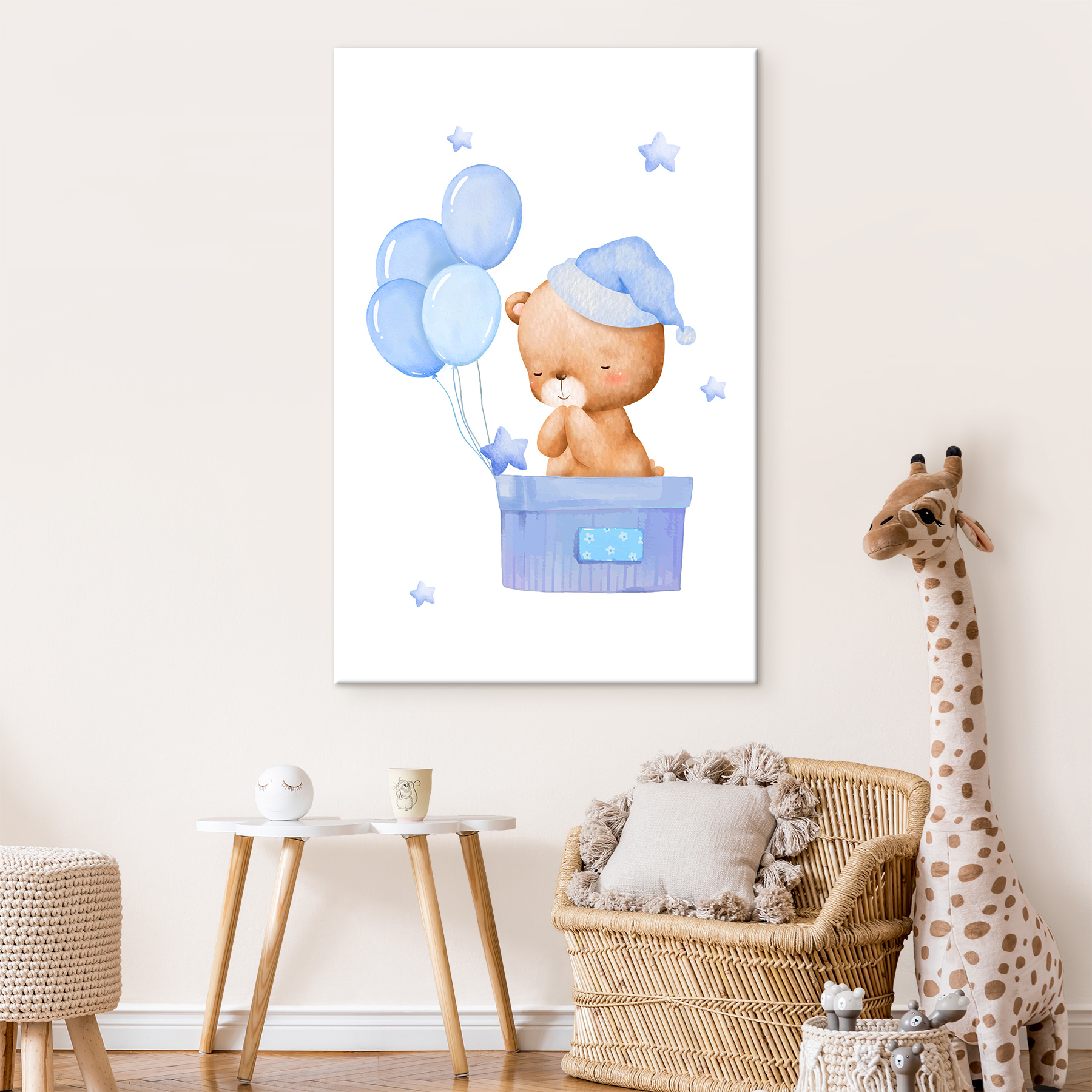 A teddy bear in a box with balloons