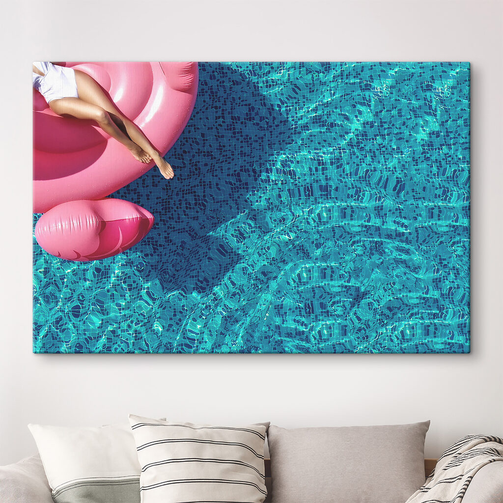 A woman on a pink float in a pool A woman on a pink float in a pool
