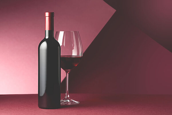 A bottle of wine next to a glass of wine A bottle of wine next to a glass of wine