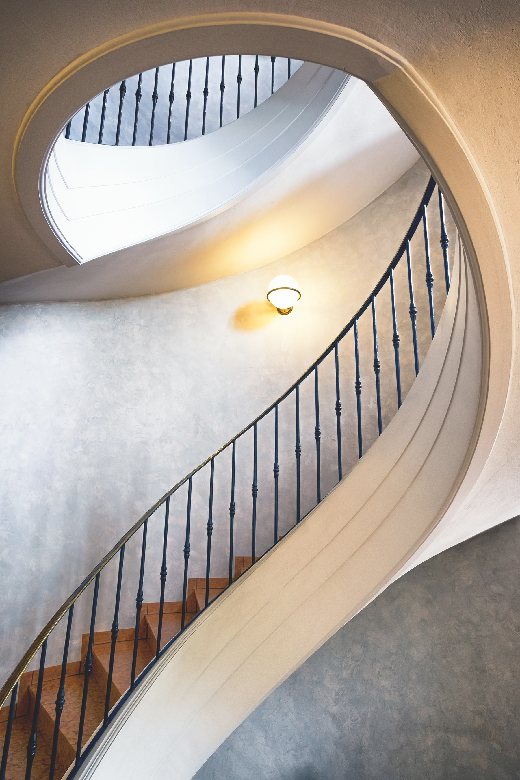 A spiral staircase with a black railing