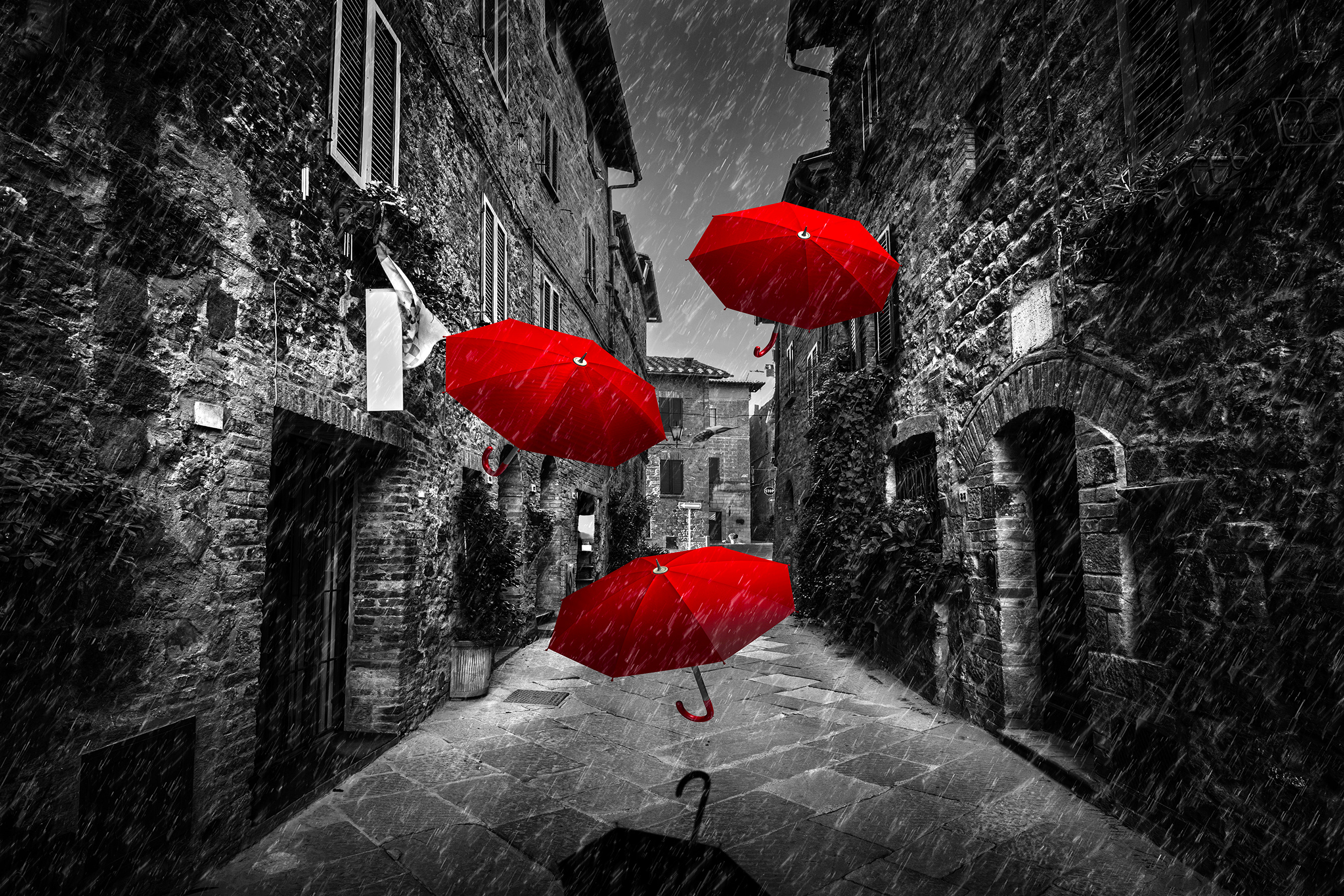 A group of red umbrellas flying in the air