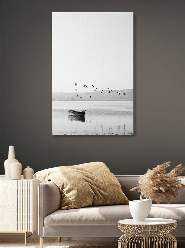 A group of birds flying over a body of water A group of birds flying over a body of water