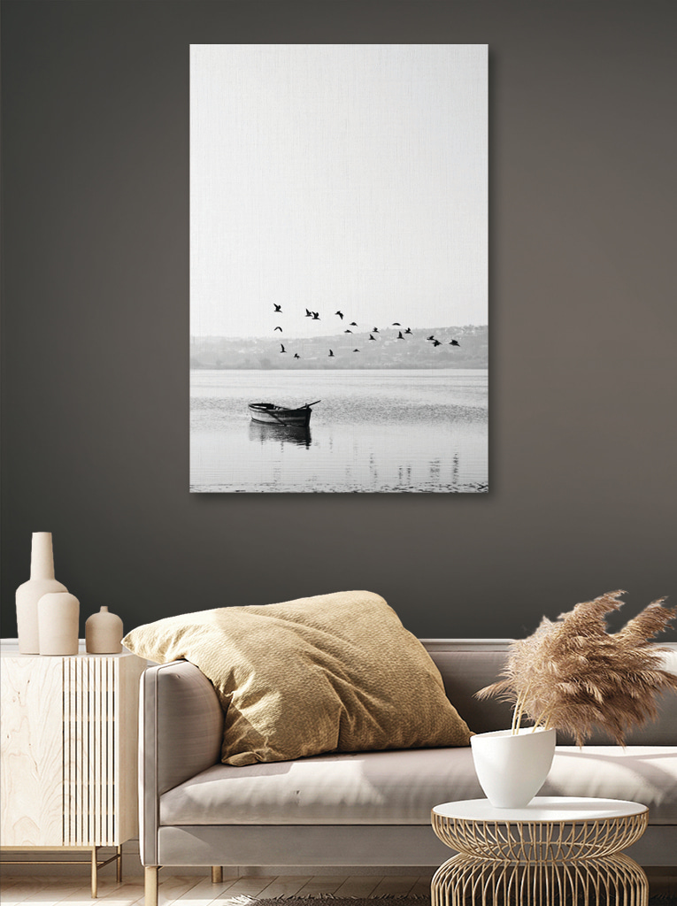 A group of birds flying over a body of water A group of birds flying over a body of water