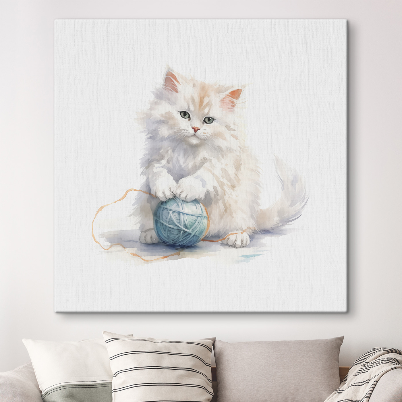 A cat playing with a ball of yarn