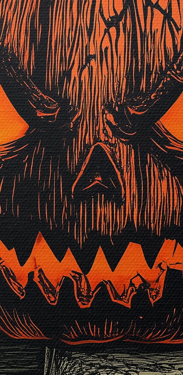 Pumpkin with a face on top of a book