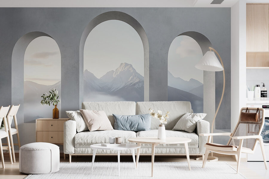 Habitación blanca con ventanas arqueadas y montañas al fondo