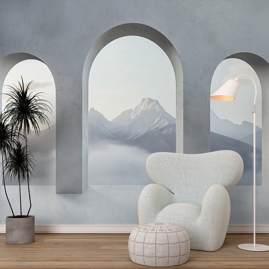 Habitación blanca con ventanas arqueadas y montañas al fondo