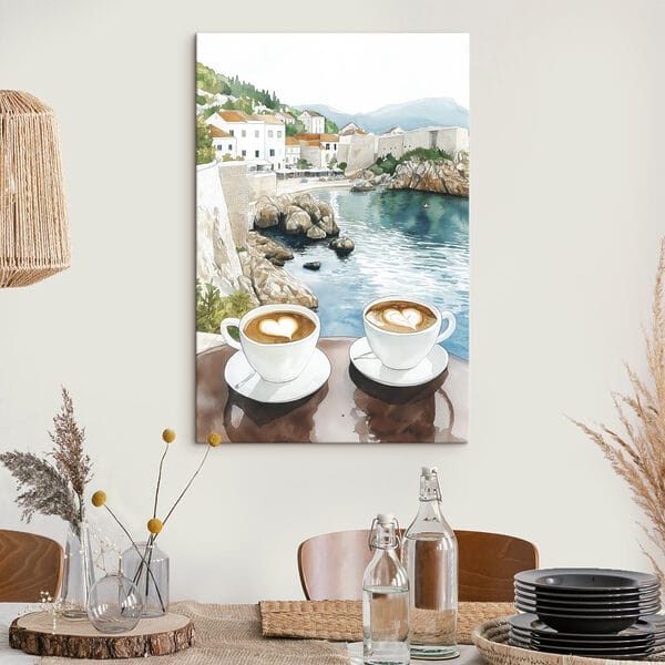 Two cups of coffee with a heart shaped foam on top of a table overlooking a body of water