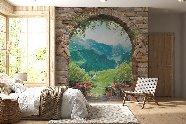 Arco de piedra con estatuas de piedra y vistas a un valle y montañas Arco de piedra con estatuas de piedra y vistas a un valle y montañas