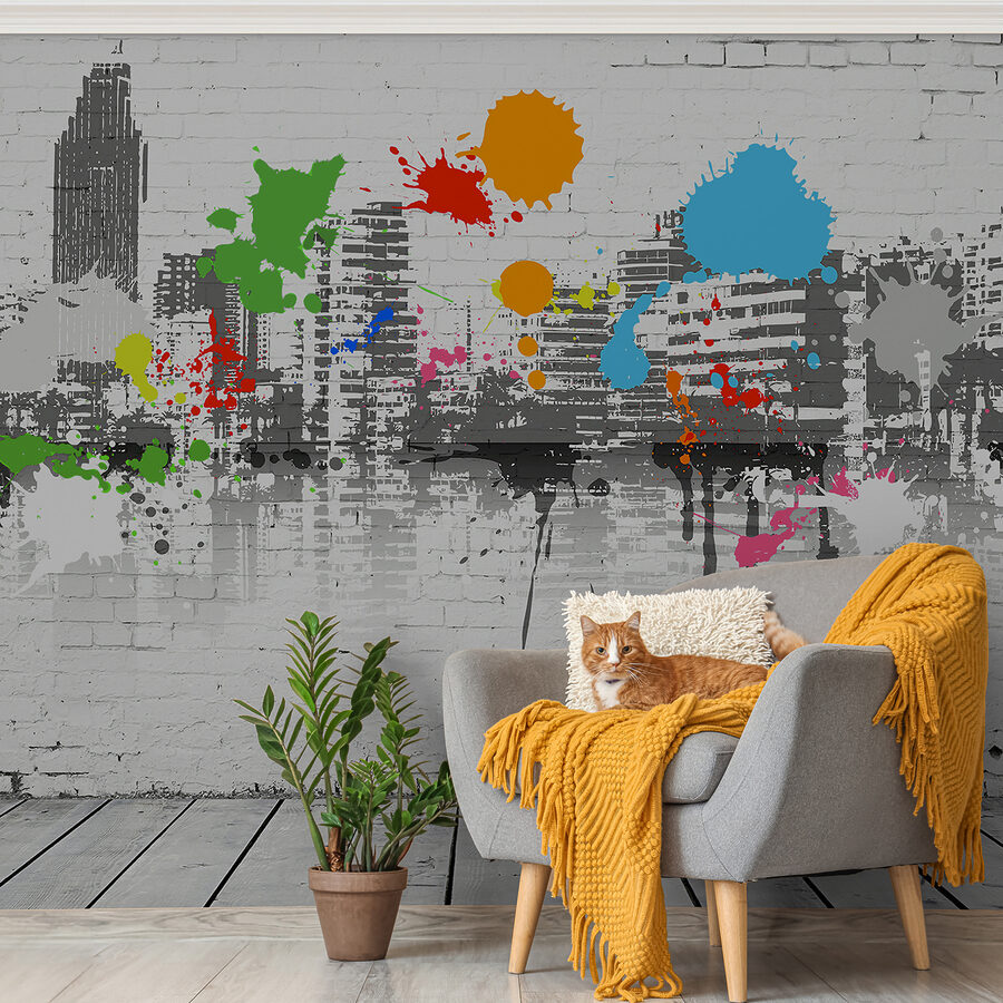 Pared de ladrillo blanco con salpicaduras de pintura de colores