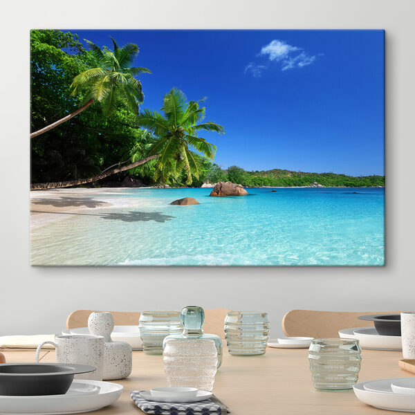 A beach with palm trees and blue water