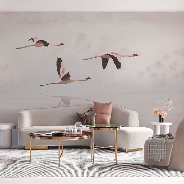 A group of flamingos flying over water A group of flamingos flying over water