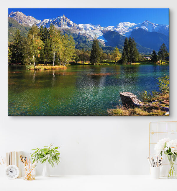 A lake surrounded by trees and mountains A lake surrounded by trees and mountains