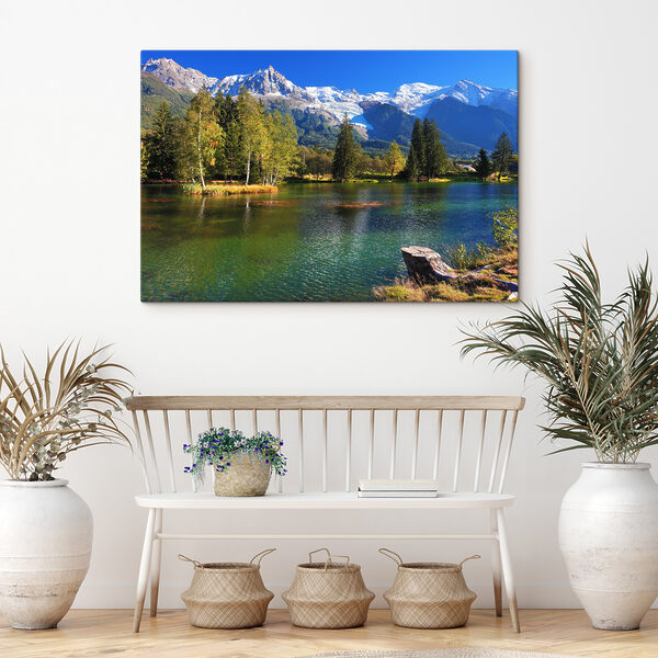 A lake surrounded by trees and mountains A lake surrounded by trees and mountains