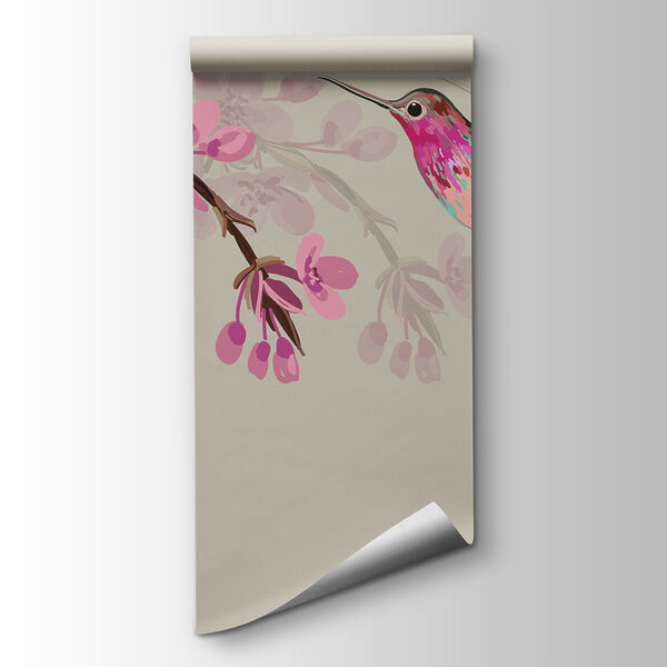 A bird flying next to a branch of flowers