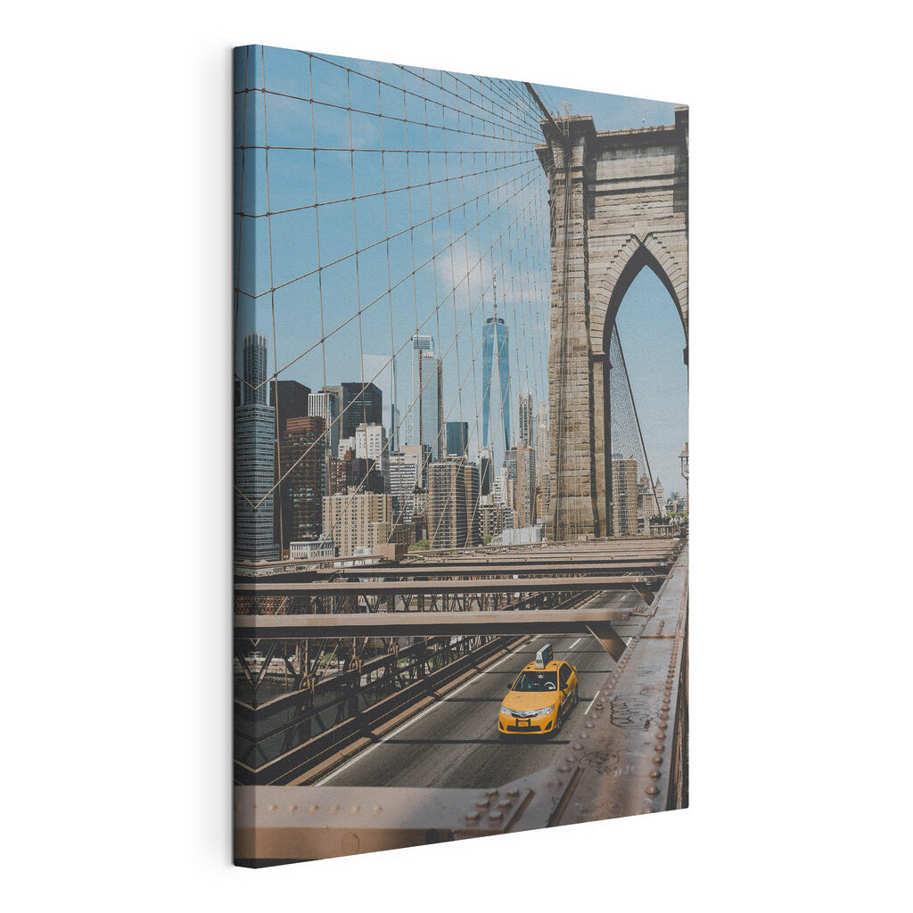 Brooklyn Bridge with a yellow taxi driving down it Brooklyn Bridge with a yellow taxi driving down it