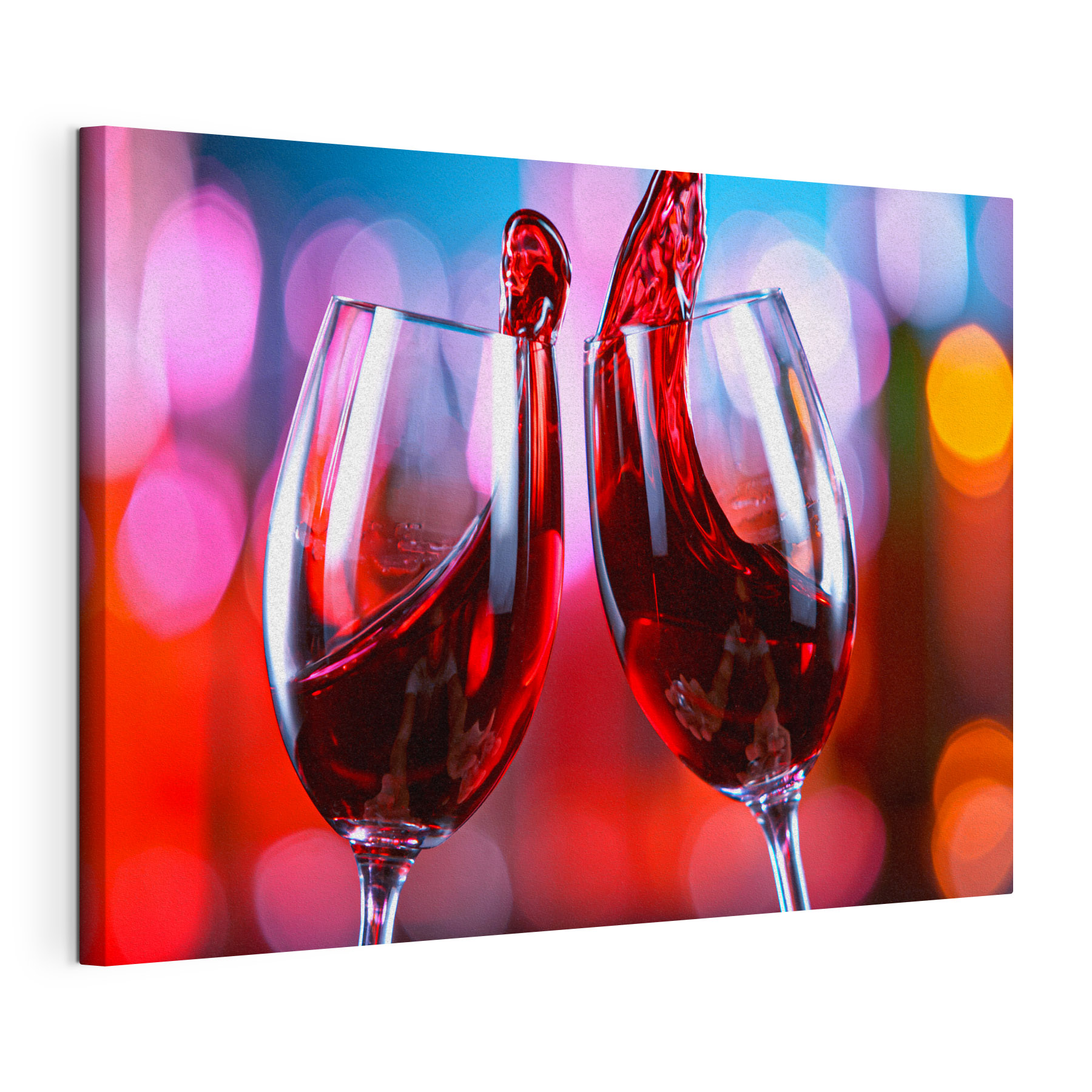 A couple of wine glasses with red liquid pouring into them