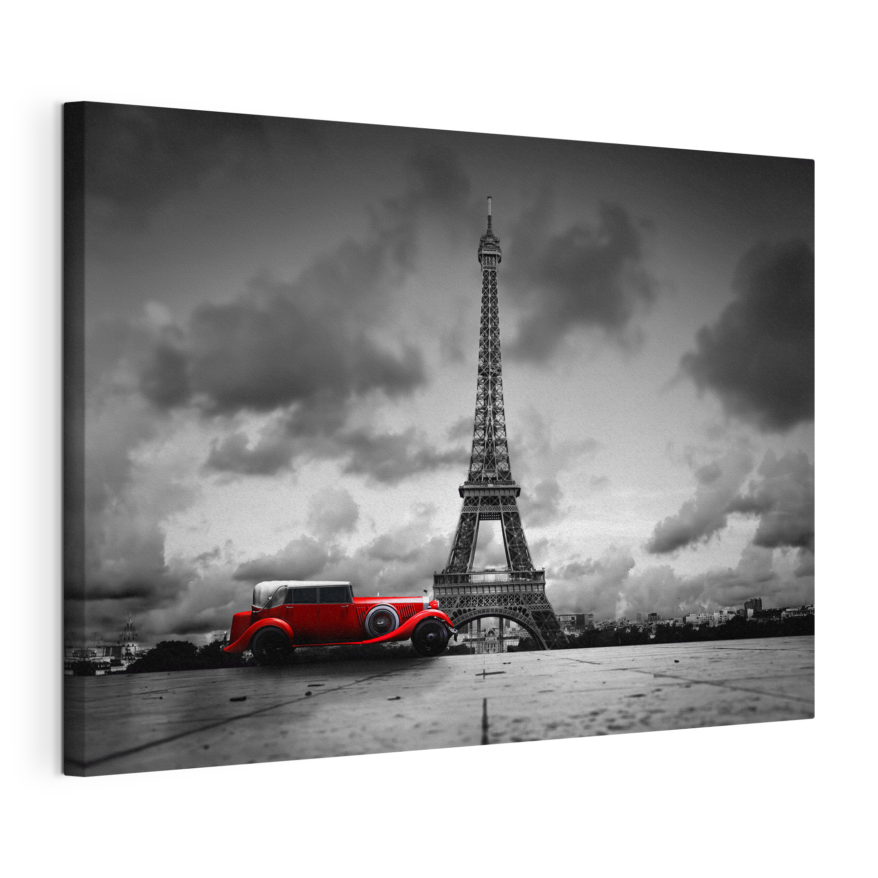 A red car parked in front of a large tower
