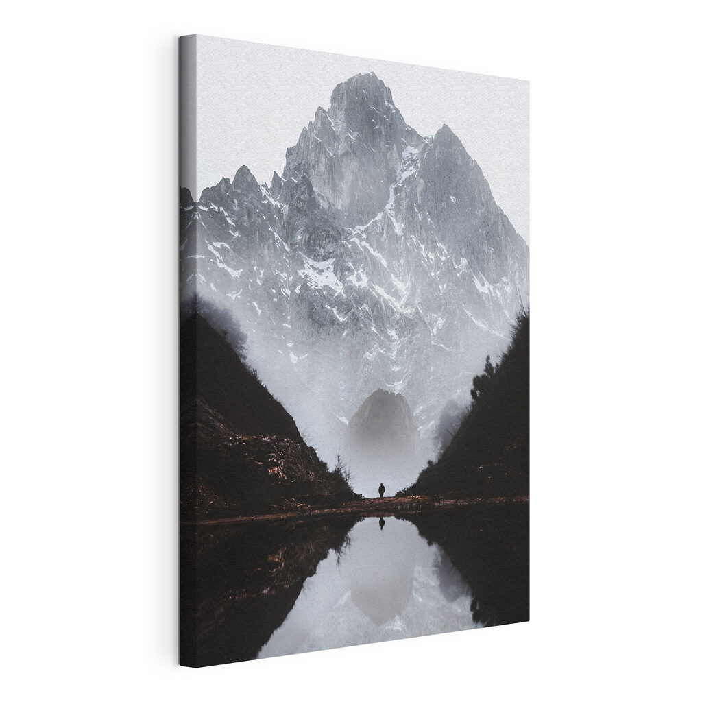 A person standing in a valley with a mountain in the background A person standing in a valley with a mountain in the background