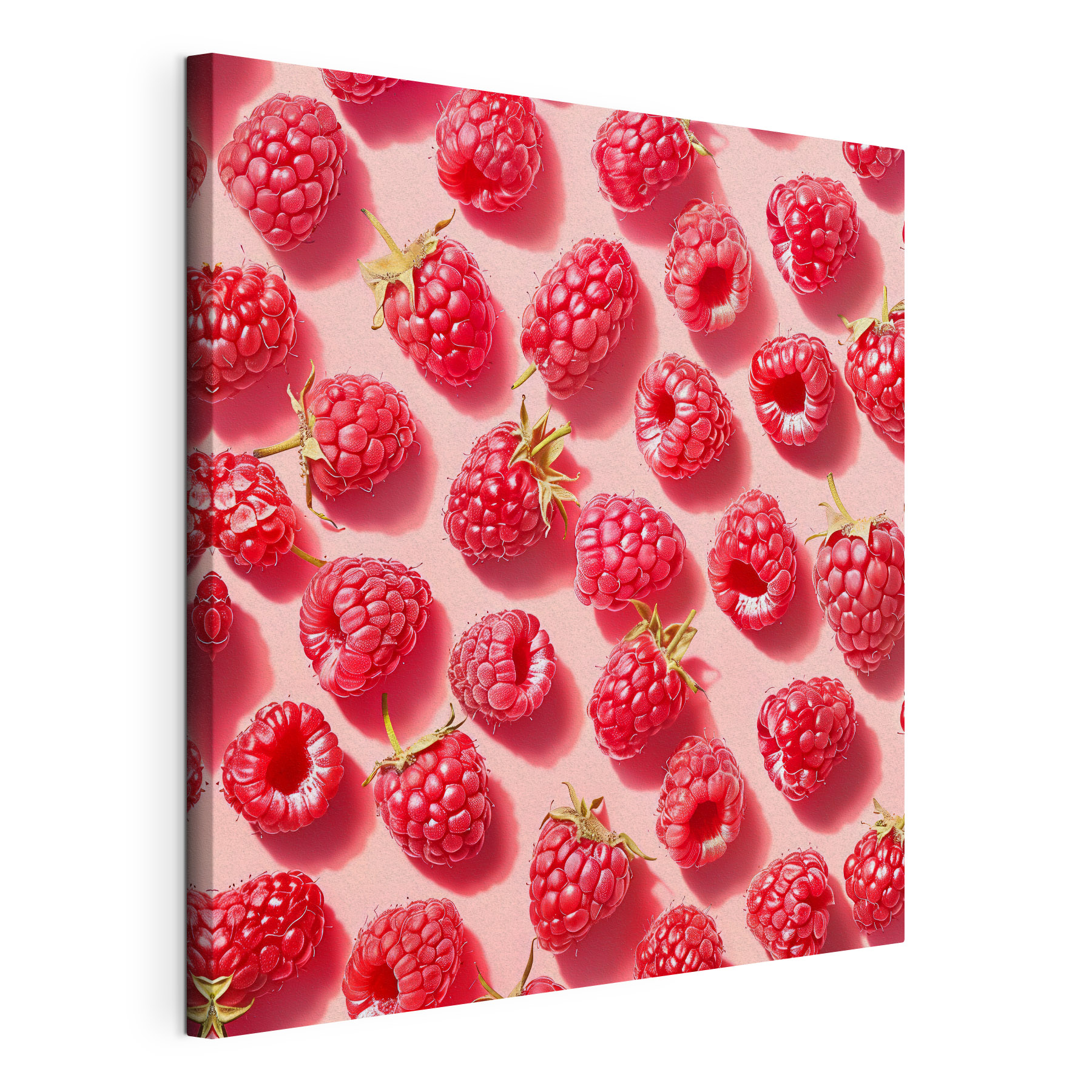 A group of raspberries on a pink surface A group of raspberries on a pink surface