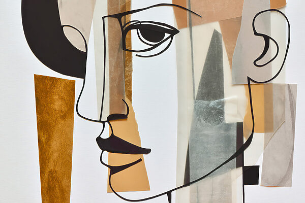 Piece of art with a face and a few pieces of paper Piece of art with a face and a few pieces of paper